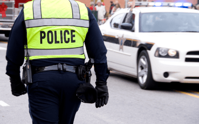 Police officer in uniform walking up the street